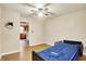 Well-lit bedroom featuring ceiling fan, hardwood floors, and comfortable hospital bed at 6308 Ratliff Rd, Indianapolis, IN 46113