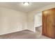 Neutral bedroom with carpet and cream walls leading to another room at 6308 Ratliff Rd, Indianapolis, IN 46113