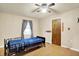 Well-lit bedroom featuring ceiling fan, hardwood floors, and comfortable hospital bed at 6308 Ratliff Rd, Indianapolis, IN 46113