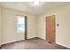 Cozy bedroom with neutral walls, brown carpet, and natural light from a window at 6308 Ratliff Rd, Indianapolis, IN 46113