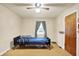 Well-lit bedroom featuring ceiling fan, hardwood floors, and comfortable hospital bed at 6308 Ratliff Rd, Indianapolis, IN 46113