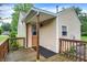 Charming front porch with wood deck and railings, providing a welcoming entrance to the home at 6308 Ratliff Rd, Indianapolis, IN 46113