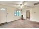 Bright living room with carpet, ceiling fan, and a view of the outdoors at 6308 Ratliff Rd, Indianapolis, IN 46113