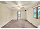 Inviting living room with carpet, ceiling fan, and large windows for bright, natural lighting at 6308 Ratliff Rd, Indianapolis, IN 46113