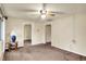 Carpeted living room with ceiling fan and access to other rooms at 6308 Ratliff Rd, Indianapolis, IN 46113