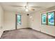 Cozy living room featuring carpet, a ceiling fan, and ample natural light at 6308 Ratliff Rd, Indianapolis, IN 46113