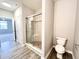 Modern bathroom featuring a glass-enclosed shower with tiled walls and a built-in seat at 6350 Stallion Way, Indianapolis, IN 46260