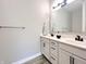 Elegant bathroom featuring double sinks with white cabinets, black hardware, and a large mirror at 6350 Stallion Way, Indianapolis, IN 46260