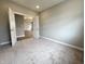Spacious bedroom features neutral carpeting and an open doorway to another room at 6350 Stallion Way, Indianapolis, IN 46260