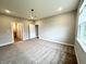 Spacious bedroom with neutral carpeting and access to other rooms and a window at 6350 Stallion Way, Indianapolis, IN 46260