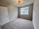 Carpeted bedroom features a window and neutral walls at 6350 Stallion Way, Indianapolis, IN 46260
