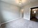 Carpeted bedroom with a view of an en-suite bathroom at 6350 Stallion Way, Indianapolis, IN 46260