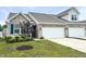 Charming townhome with brick facade, two-car garage, and freshly landscaped front yard at 6350 Stallion Way, Indianapolis, IN 46260