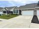 Well-maintained townhome featuring brickwork, a two-car garage, and a paved driveway at 6350 Stallion Way, Indianapolis, IN 46260
