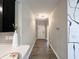 Bright hallway leading through the home features wood-look flooring and modern lighting at 6350 Stallion Way, Indianapolis, IN 46260
