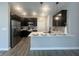 Modern kitchen features stainless steel appliances, dark cabinets, and a breakfast bar with stylish pendant lighting at 6350 Stallion Way, Indianapolis, IN 46260
