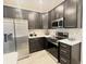 Well-equipped kitchen with dark cabinetry, stainless steel appliances, and subway tile backsplash at 6350 Stallion Way, Indianapolis, IN 46260