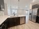 Kitchen featuring stainless appliances, modern fixtures, and open view to the living area at 6350 Stallion Way, Indianapolis, IN 46260