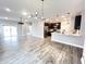 Spacious living area with open layout, showcasing stylish flooring and a modern kitchen at 6350 Stallion Way, Indianapolis, IN 46260
