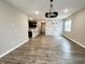 Open concept living space with luxury vinyl plank flooring and modern lighting fixtures at 6350 Stallion Way, Indianapolis, IN 46260
