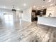 Open concept living space with luxury vinyl plank flooring and stainless steel appliances at 6350 Stallion Way, Indianapolis, IN 46260