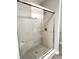 Contemporary glass-enclosed shower with tiled walls, a rainfall showerhead, and sleek hardware at 6350 Stallion Way, Indianapolis, IN 46260