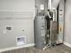Utility room with water heater, furnace and vinyl flooring at 6350 Stallion Way, Indianapolis, IN 46260