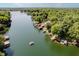 Picturesque aerial view of a tranquil lake surrounded by lush forests and waterfront homes at 6492 Osprey Dr, Nineveh, IN 46164