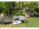 Scenic aerial view of waterfront home with boat dock, lush greenery, and clear water at 6492 Osprey Dr, Nineveh, IN 46164