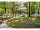 Beautiful backyard with lush greenery and a view of the tranquil lake at 6492 Osprey Dr, Nineveh, IN 46164