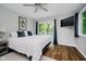 Comfortable bedroom features a large bed, wall mounted television and sliding doors to the balcony at 6492 Osprey Dr, Nineveh, IN 46164