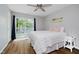 Bright bedroom featuring hardwood floors, ceiling fan, and sliding door to a private balcony at 6492 Osprey Dr, Nineveh, IN 46164