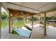 Covered boat dock featuring waterfront seating and watercraft lift on a sunny day at 6492 Osprey Dr, Nineveh, IN 46164