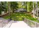 Beautifully landscaped exterior view of a home nestled among mature trees with a spacious deck at 6492 Osprey Dr, Nineveh, IN 46164