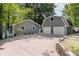Spacious gravel driveway leading to a two-car garage and a separate, smaller matching storage shed at 6492 Osprey Dr, Nineveh, IN 46164