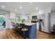 Bright eat-in kitchen with stainless steel appliances, stone countertops, and backyard views at 6492 Osprey Dr, Nineveh, IN 46164