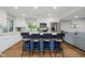 Open kitchen features an eat-in island with wood stools, white cabinets, and recessed lighting at 6492 Osprey Dr, Nineveh, IN 46164