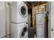 Laundry room with stacked washer and dryer next to water heater at 6492 Osprey Dr, Nineveh, IN 46164