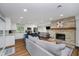 Open-concept living space with stone fireplace, modern kitchen, and comfortable seating, great for entertaining at 6492 Osprey Dr, Nineveh, IN 46164