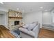 Inviting living room with stone fireplace, wood mantel, and luxury vinyl flooring at 6492 Osprey Dr, Nineveh, IN 46164