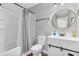 This well lit bathroom features a shower, toilet and vanity sink at 6853 Kellum Dr, Indianapolis, IN 46221