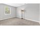 This carpeted bedroom features natural light through the window and neutral walls at 6853 Kellum Dr, Indianapolis, IN 46221