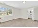 Bright bedroom with a view of the backyard and an open doorway to an attached bathroom at 6853 Kellum Dr, Indianapolis, IN 46221