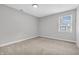 Neutral colored bedroom with carpet, window, and overhead lighting at 6853 Kellum Dr, Indianapolis, IN 46221