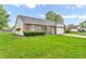 Well manicured single-story home with lush lawn, a two-car garage, and tidy landscaping at 6853 Kellum Dr, Indianapolis, IN 46221