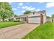 Well maintained single-story home with brick accents, long driveway and a two-car garage at 6853 Kellum Dr, Indianapolis, IN 46221