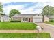 Charming single-story home with brick and siding, landscaped front yard and a two-car garage at 6853 Kellum Dr, Indianapolis, IN 46221