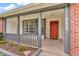 Inviting front porch with a red front door and decorative welcome mat provides curb appeal at 6853 Kellum Dr, Indianapolis, IN 46221