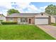 Charming single-Gathering home featuring a manicured lawn, red front door, and attached two-car garage at 6853 Kellum Dr, Indianapolis, IN 46221
