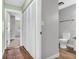Hallway with wood flooring, a linen closet and a doorway to the bathroom at 6853 Kellum Dr, Indianapolis, IN 46221